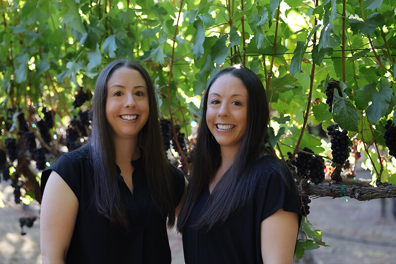 Jenna & Mara York, founders of JennaMarise Winery in a vineyard.